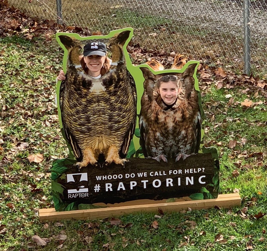 students putting faces in owl cutout